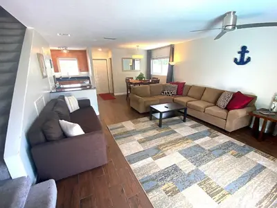 a living room with two couches and a rug at Tarpon Harbor 1 - Waterfront pool home near beach & downtown Las Olas in Fort Lauderdale