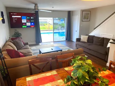 a living room with a couch and a table at Tarpon Harbor 1 - Waterfront pool home near beach & downtown Las Olas in Fort Lauderdale