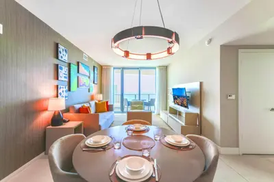 a dining room and living room with a table and chairs at Spectacular Sunset Views Over the Ocean at Hollywood in Hollywood