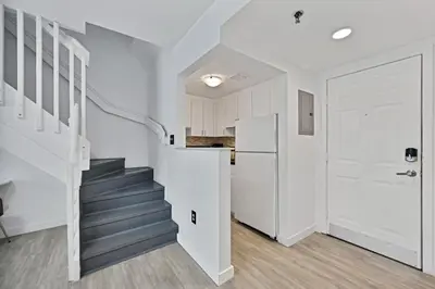 a staircase in a white room with a white door at Sunny Miami Beach Retreat in Miami Beach