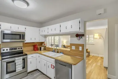 a kitchen with white cabinets and a sink at MiaBella of Hollywood home in Hollywood