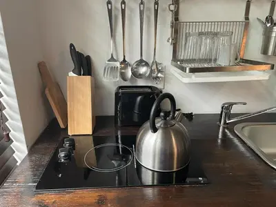 a tea kettle on a stove in a kitchen at Vive Zen Queen Room in Miami