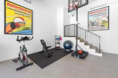 a room with a gym with a basketball hoop and bikes at Best Bayfront View New construction w pool in Miami Beach