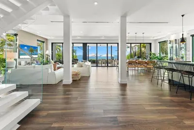 an open living room with white furniture and tables at Best Bayfront View New construction w pool in Miami Beach