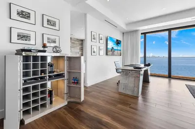an office with a desk and a view of the water at Best Bayfront View New construction w pool in Miami Beach