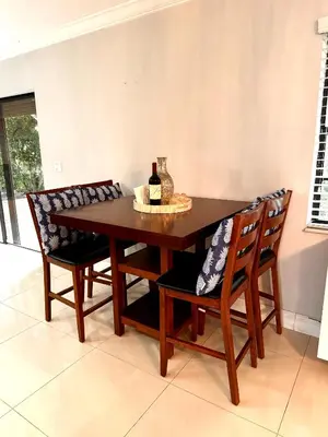 a dining room table with two chairs and a bottle of wine at Modern Miami Oversized 3 Bedroom in Central Location in Miami