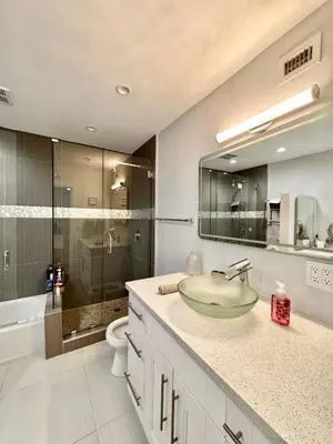 a bathroom with a sink and a glass shower at Modern Miami Oversized 3 Bedroom in Central Location in Miami