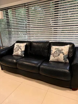 a black leather couch with two pillows on it at Modern Miami Oversized 3 Bedroom in Central Location in Miami
