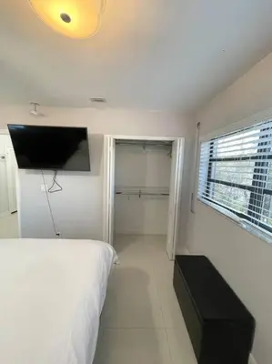 a bedroom with a bed and a flat screen tv at Modern Miami Oversized 3 Bedroom in Central Location in Miami