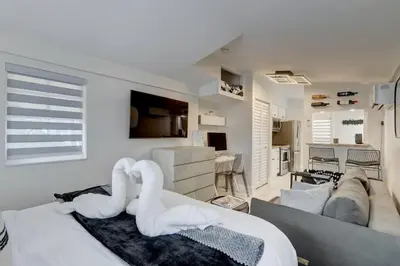 a room with a bed and a living room at Laguna @ Casa Del Sol in Fort Lauderdale