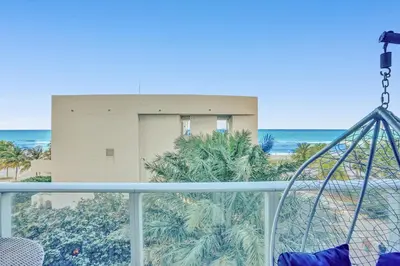 a balcony with a view of the ocean and a building at Oceanfront Condo Direct Ocean & Beach Club Access in Hollywood