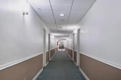 an empty hallway with a long aisle in an office building at Ocean View Modern Condo Beach Access 11M in Hollywood