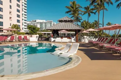 a pool at a resort with chairs and a gazebo at 3 Bedroom Apt Ocean-Front Resort The Alexander in Miami Beach