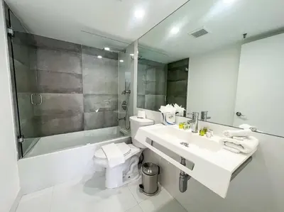 a bathroom with a sink and a toilet and a shower at 3 Bedroom Apt Ocean-Front Resort The Alexander in Miami Beach