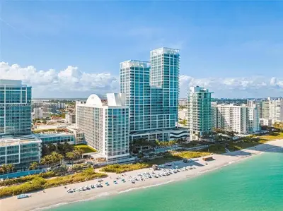 an aerial view of a city with tall buildings and a beach at Ocean View Luxury Carillon Condo at Beach Access C616 in Miami Beach