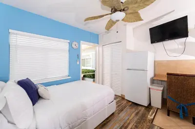 a bedroom with a white bed and a ceiling fan at Tropic Isle Boutique Hotel in Hollywood