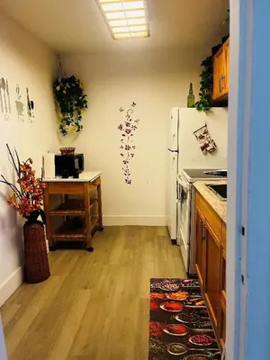 a kitchen with a table and a white refrigerator at Home Sweet Home in Miami