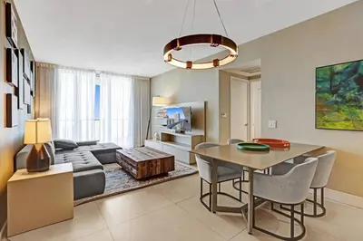 a living room with a table and a couch at Chic 2BDR 2BA Water Front in Hyde Beach in Hollywood