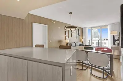 a kitchen and dining room with a large white island at Chic 2BDR 2BA Water Front in Hyde Beach in Hollywood
