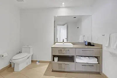 a bathroom with a toilet and a sink and a mirror at Chic 2BDR 2BA Water Front in Hyde Beach in Hollywood