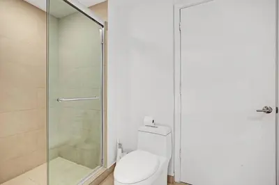 a bathroom with a toilet and a glass shower at Chic 2BDR 2BA Water Front in Hyde Beach in Hollywood