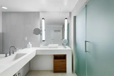 a bathroom with a large sink and a mirror at Resort-Style Residence Beachfront Condo Oasis in Fort Lauderdale