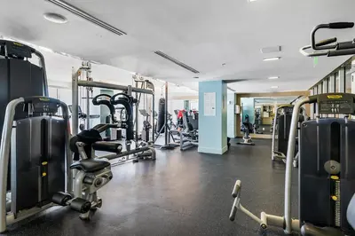 a gym with treadmills and machines in a room at Resort-Style Residence Beachfront Condo Oasis in Fort Lauderdale