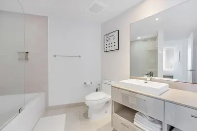 a white bathroom with a sink and a toilet at Heaven Resort - 2BDR BEACH HOME WITH OCEAN VIEW HOLLYWOOD! in Hollywood