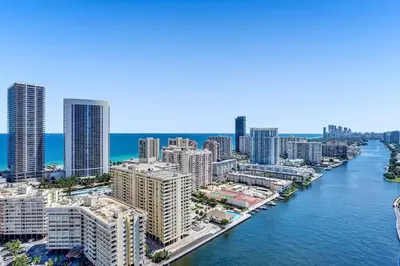 an aerial view of a city with a river and buildings at Sky-High Spacious Ocean View Condo 4 BDRS 3 BATH in Hallandale Beach