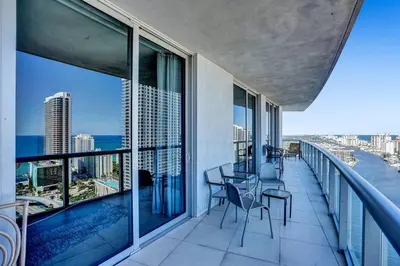 a balcony with a view of the ocean on a building at Sky-High Spacious Ocean View Condo 4 BDRS 3 BATH in Hallandale Beach
