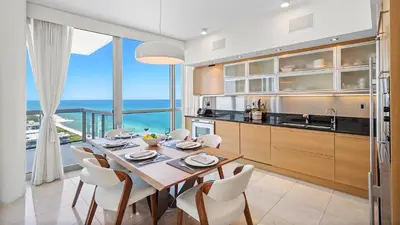 a kitchen and dining room with a table and chairs at Oceanview Private Penthouse Condo at The Setai -3903 in Miami Beach