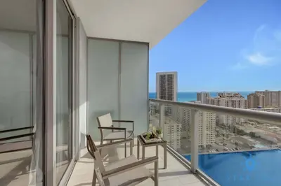 a balcony with a chair and a view of the city at Infinite View - Balcony - Gym - Pool in Hallandale Beach