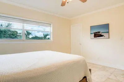 a white bedroom with a bed and a window at Intracoastal Oasis in a Prime Area w Pool and BBQ in Fort Lauderdale