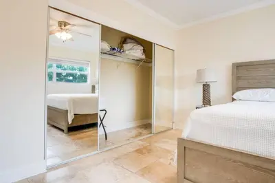 a bedroom with a bed and a mirror at Intracoastal Oasis in a Prime Area w Pool and BBQ in Fort Lauderdale