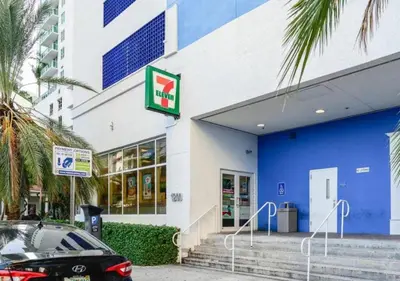 a blue and white building with a car parked outside at Stunning 1/1 Condo @Brickell Free Parking/Pool in Miami
