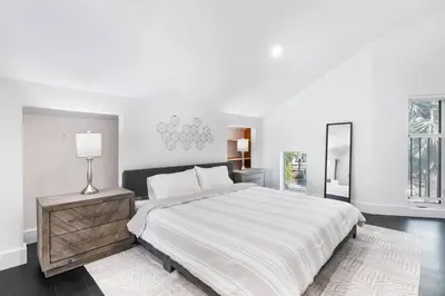 a white bedroom with a large bed and a lamp at Best Sunset View on the Bay with Pool in Miami Beach