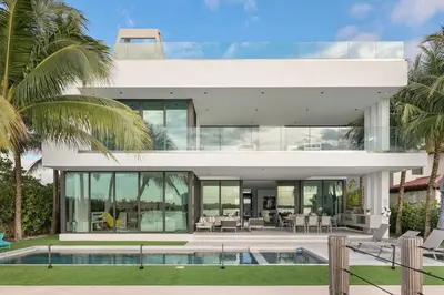 a large white house with a pool and palm trees at Best Sunset Bayfront - pool jacuzzi pool table in Miami Beach