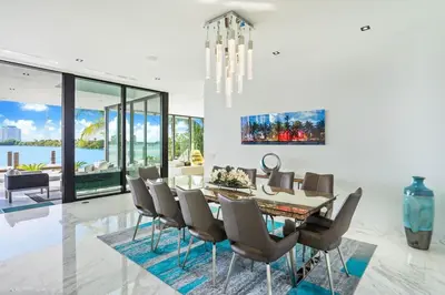 a dining room with a table and chairs at Best Sunset Bayfront - pool jacuzzi pool table in Miami Beach