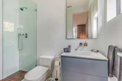 a bathroom with a toilet and a sink and a shower at Best Sunset Bayfront - pool jacuzzi pool table in Miami Beach