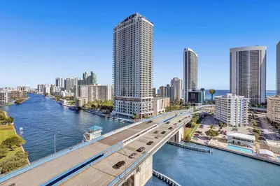 a bridge over a river in a city with tall buildings at Lovely 3 bedroom 3 bathroom ocean front in Hallandale Beach