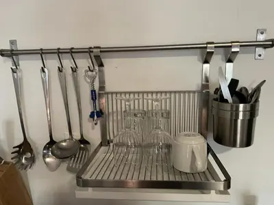 a metal rack with utensils hanging on a wall at Vive Zen Queen Room in Miami