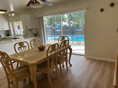 a kitchen and dining room with a wooden table and chairs at Airbnb rental in Miami