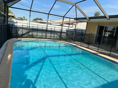 a large swimming pool with blue water in a building at Airbnb rental in Miami