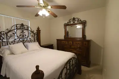 a bedroom with a bed and a mirror and a ceiling fan at Airbnb rental in Miami