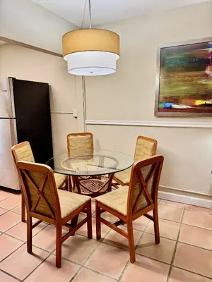 a dining room with a glass table and chairs at Silver Seas Beach Resort in Fort Lauderdale