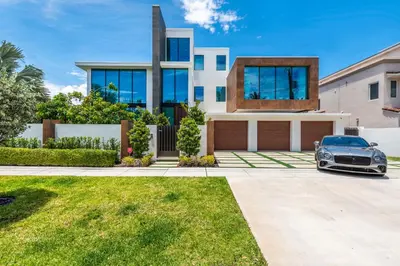 a house with a car parked in front of it at Boardwalk Mansion in Fort Lauderdale