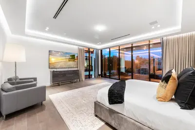 a bedroom with a large bed and a television at Boardwalk Mansion in Fort Lauderdale