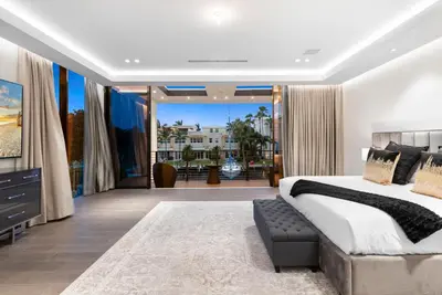 a bedroom with a large bed and a large window at Boardwalk Mansion in Fort Lauderdale