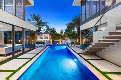 a swimming pool in the backyard of a house at Park Place Mansion in Fort Lauderdale