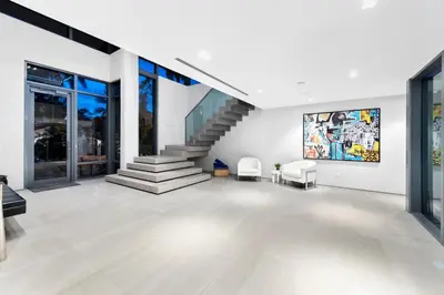 a living room with a staircase and a stair case at Park Place Mansion in Fort Lauderdale